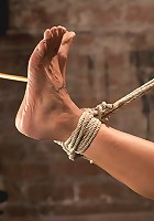 Sexy Amber has her elbows bound together, ankles to neck, and endures foot canning, brutal orgasms.