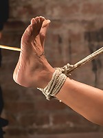 Sexy Amber has her elbows bound together, ankles to neck, and endures foot caning, brutal orgasms.