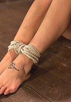 Sexy Amber has her elbows bound together, ankles to neck, and endures foot caning, brutal orgasms.