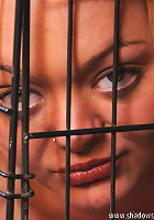 Blond slave trapped inside a dog cage
