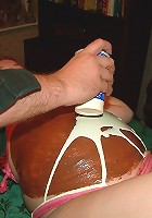 Pregnant girl with pink hair gets her belly covered with food