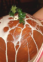 Pregnant girl with pink hair gets her belly covered with food