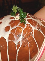 Pregnant girl with pink hair gets her belly covered with food