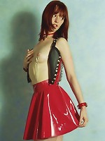 Beautiful girl in red rubber skirt and black corsette