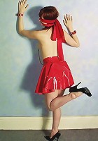 Beautiful girl in red rubber skirt and black corsette