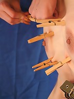 Bound slave girl gets clothespins all over her body