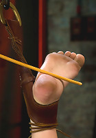 Blond with killer natural body, is suspended, suffers intense foot caningMade to cum over & over